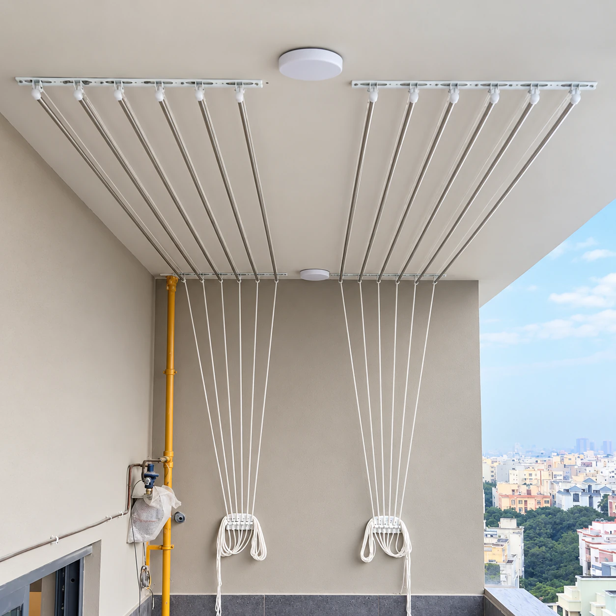 Two pulley-operated ceiling cloth hangers on an apartment balcony